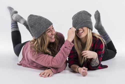 Two women wearing wool hat and wool socks.
